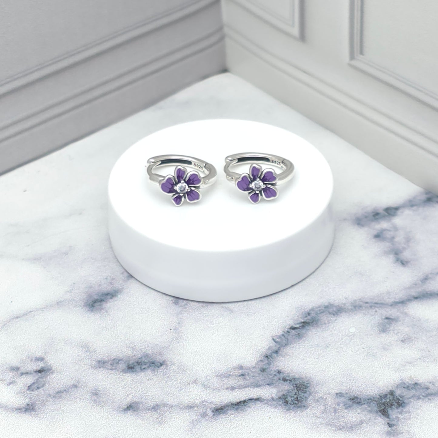 Aretes tipo argolla con flor esmaltada en lila